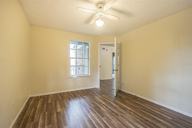 empty room featuring a textured ceiling, ceiling fan, and dark wood-type flooring