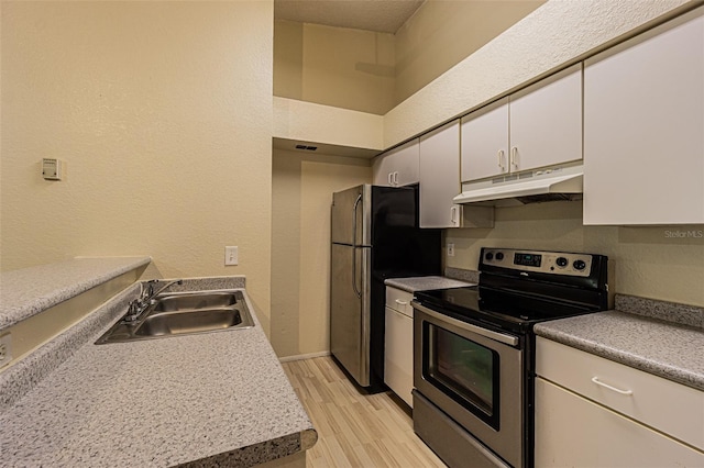 kitchen featuring sink, light hardwood / wood-style flooring, a textured ceiling, white cabinetry, and stainless steel appliances