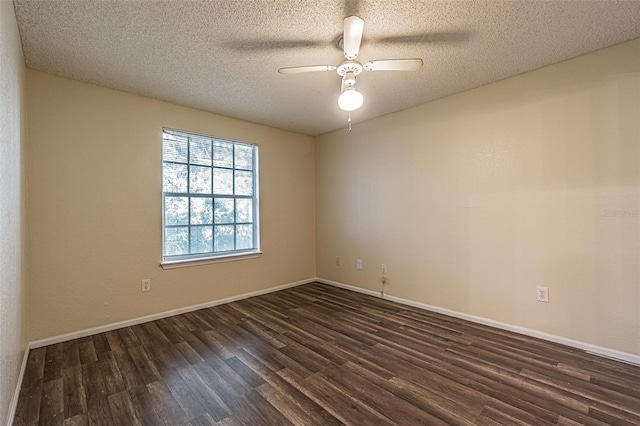 empty room with a textured ceiling, ceiling fan, and dark hardwood / wood-style floors