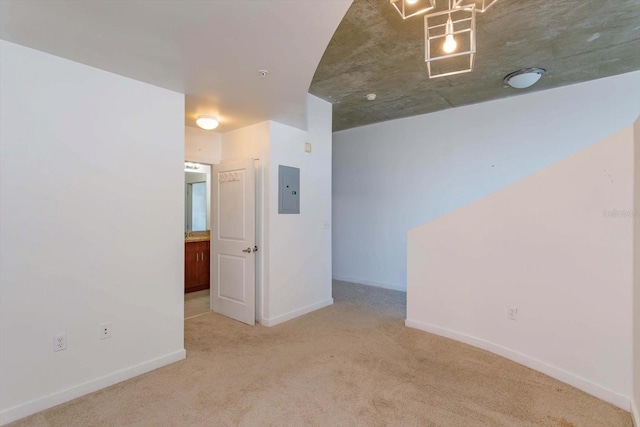 empty room with electric panel and light carpet