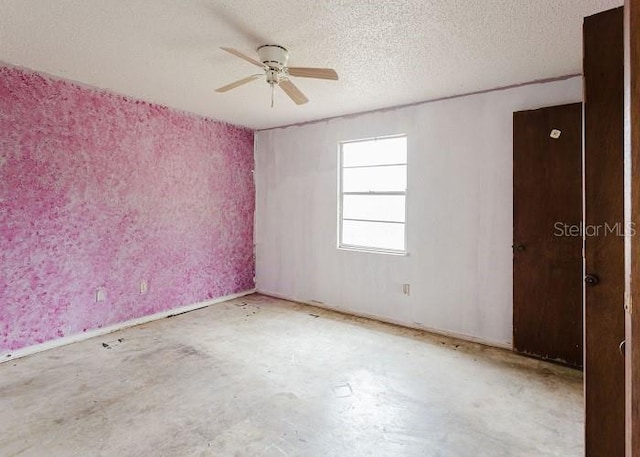 unfurnished room featuring a textured ceiling, ceiling fan, and unfinished concrete floors