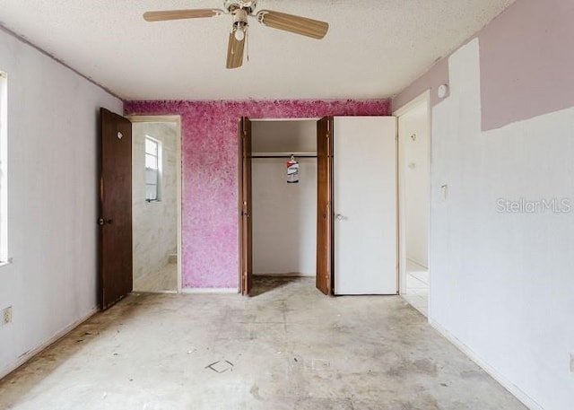 unfurnished bedroom featuring unfinished concrete floors, a ceiling fan, and a textured ceiling