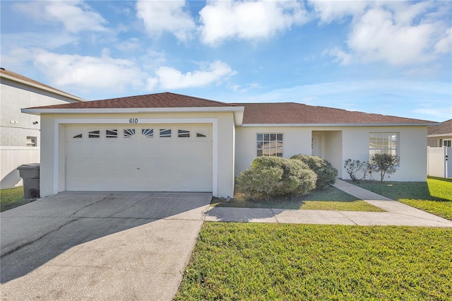 ranch-style house with a garage and a front lawn