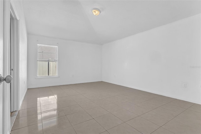 spare room featuring light tile patterned flooring