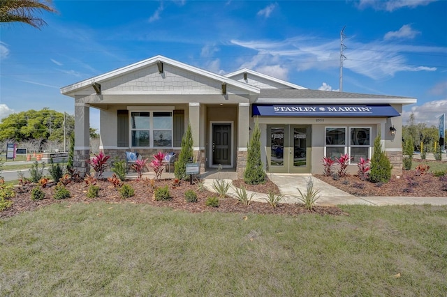 view of front facade featuring a front yard and french doors