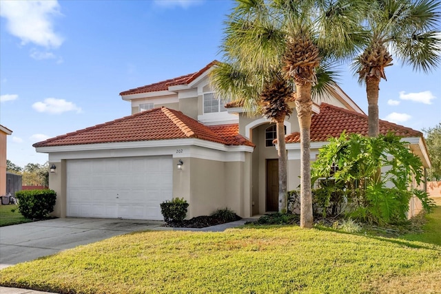 mediterranean / spanish-style home with a garage and a front lawn