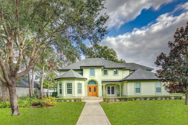 view of front of house with a front yard and french doors