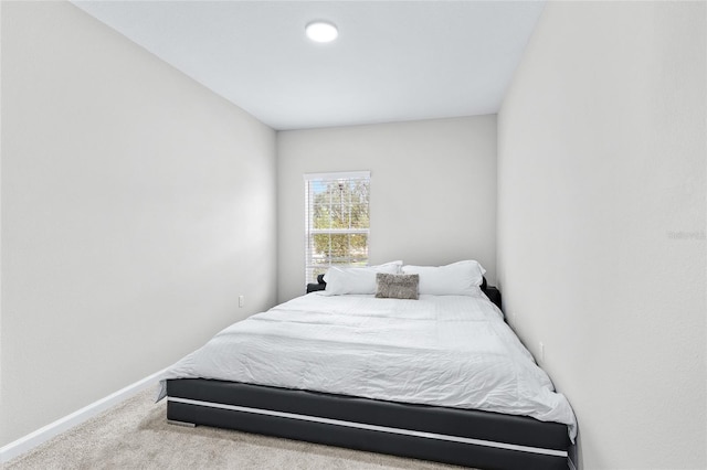 bedroom featuring light colored carpet