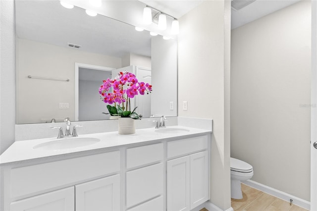 bathroom featuring hardwood / wood-style floors, vanity, and toilet