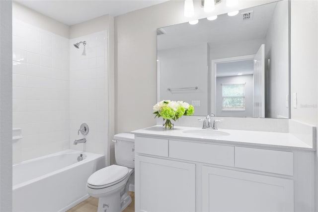 full bathroom with vanity, toilet, and tiled shower / bath