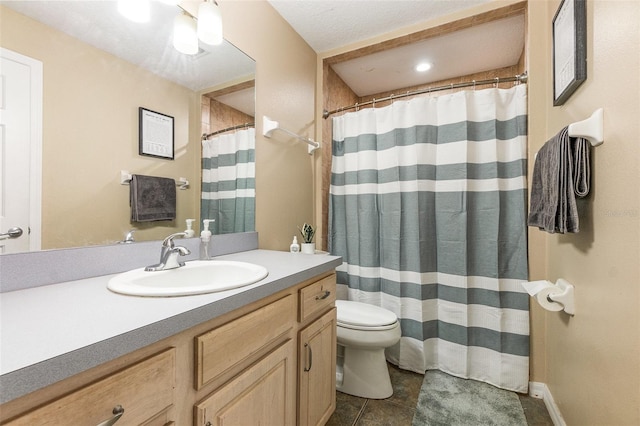 bathroom with tile patterned flooring, vanity, and toilet