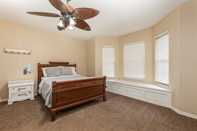 bedroom featuring ceiling fan and dark colored carpet