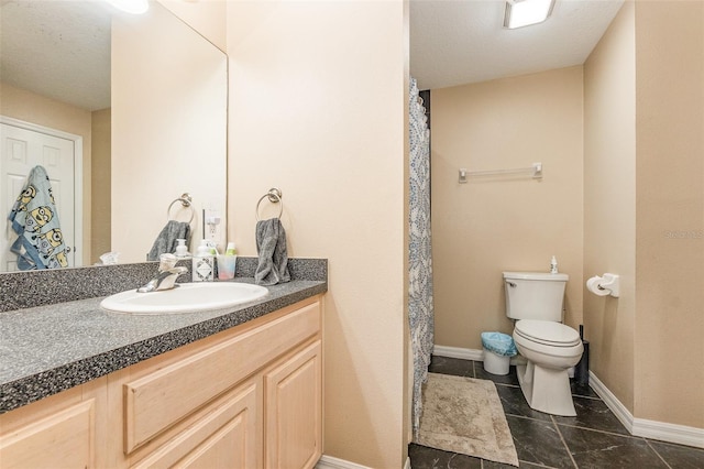 bathroom with tile patterned flooring, vanity, and toilet