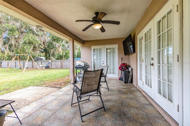 view of patio / terrace with french doors, a playground, and ceiling fan