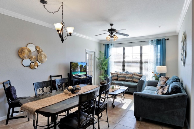 dining room with tile patterned flooring, ceiling fan with notable chandelier, and ornamental molding