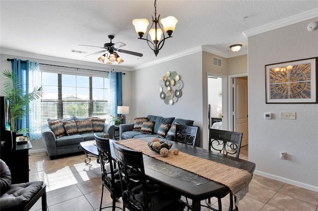 dining room featuring tile patterned flooring, ceiling fan with notable chandelier, and crown molding