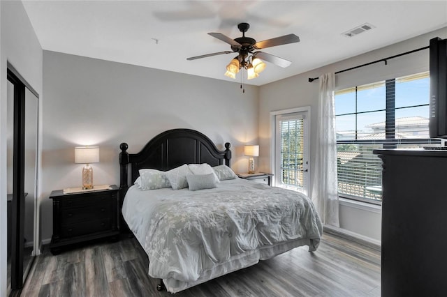 bedroom featuring ceiling fan, dark hardwood / wood-style floors, and access to outside