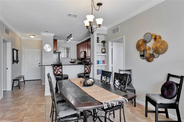 tiled dining area featuring built in shelves, an inviting chandelier, and crown molding