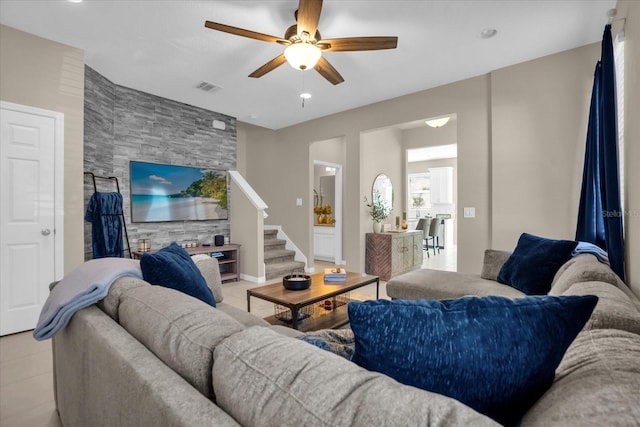 living room featuring light tile patterned floors and ceiling fan