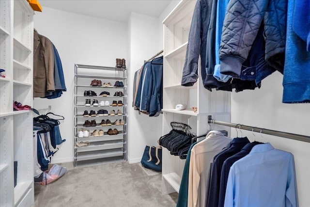 walk in closet featuring light carpet