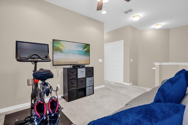 interior space with carpet flooring and ceiling fan