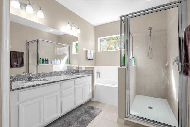 bathroom featuring shower with separate bathtub, vanity, and tile patterned floors