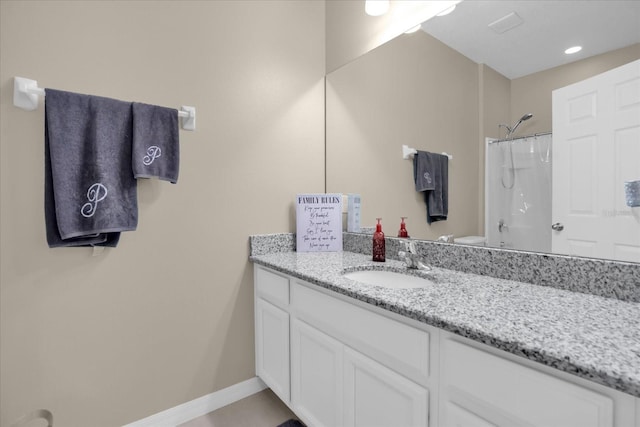 bathroom with toilet, vanity, and a shower with shower curtain