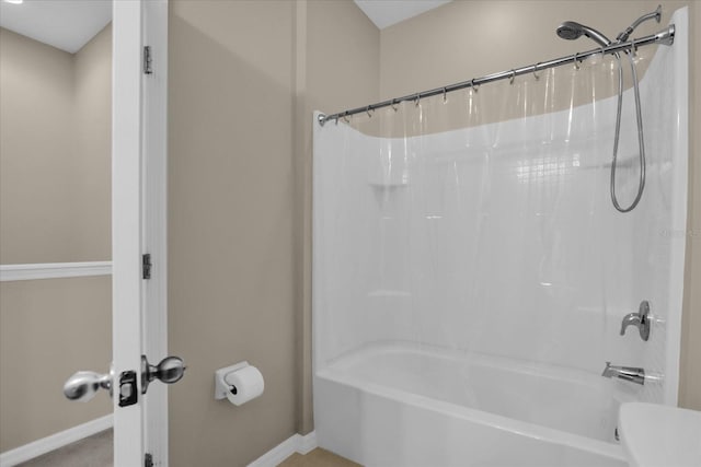 bathroom with shower / bath combo with shower curtain