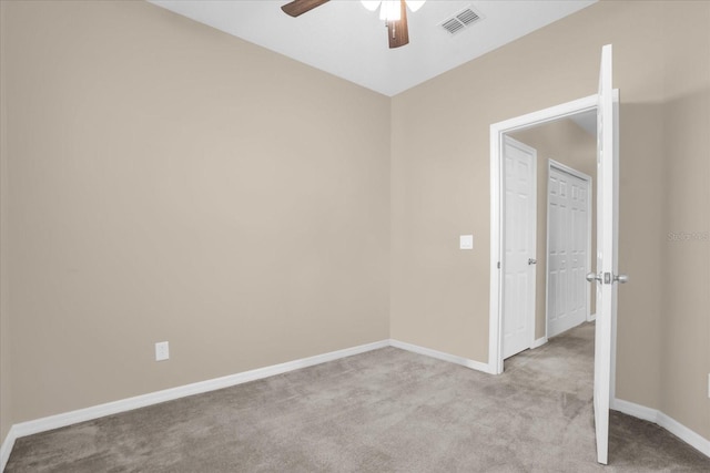 carpeted empty room with ceiling fan