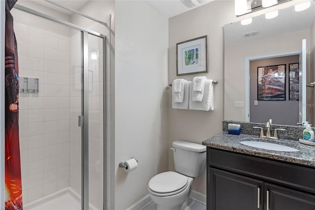 bathroom with vanity, toilet, an enclosed shower, and a textured ceiling