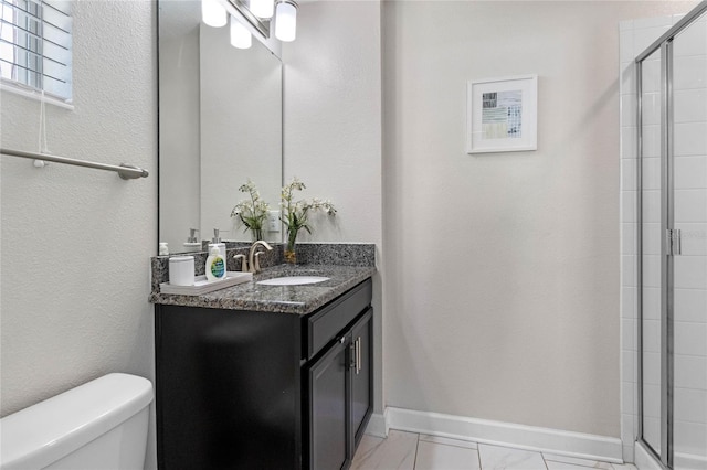 bathroom with vanity, toilet, and an enclosed shower