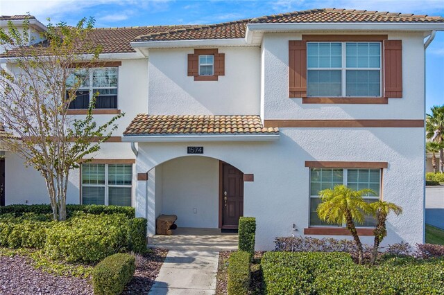 mediterranean / spanish-style home featuring a tile roof and stucco siding