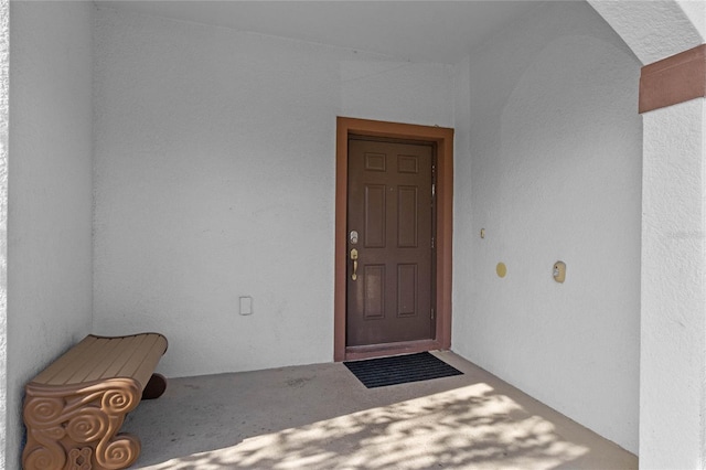 entrance to property featuring stucco siding