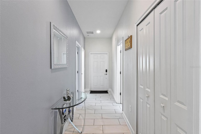 corridor featuring recessed lighting, marble finish floor, and baseboards