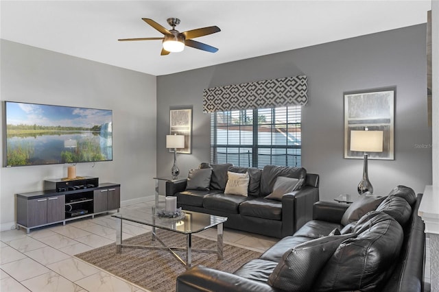 living room featuring marble finish floor, baseboards, and ceiling fan