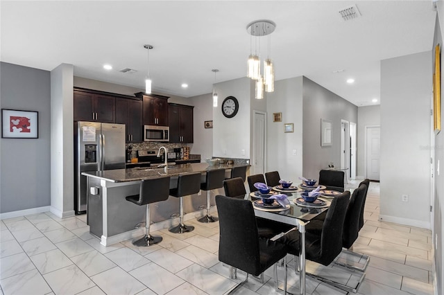 dining space with marble finish floor, baseboards, visible vents, and recessed lighting