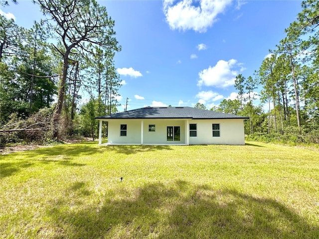 1523 W Citrus Springs Blvd, Citrus Springs, FL 34434 - rear view of house featuring stucco siding and a yard