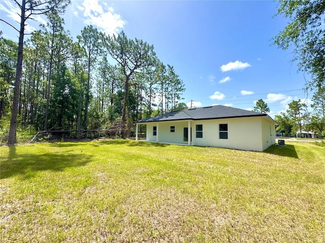 1523 W Citrus Springs Blvd, Citrus Springs, FL 34434 - rear view of property featuring stucco siding and a yard