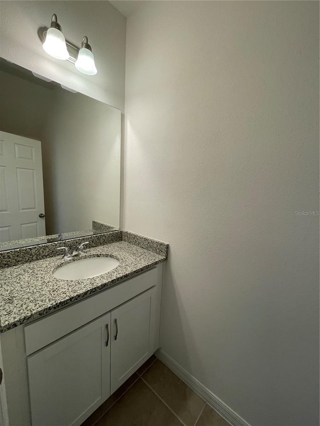 bathroom featuring tile patterned flooring and vanity