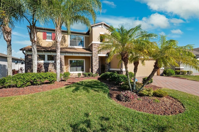 view of front of home with a front yard and a garage