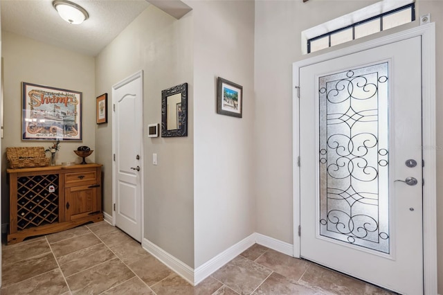 foyer entrance with a textured ceiling