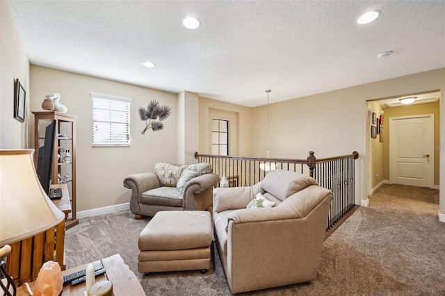 carpeted living room featuring a textured ceiling