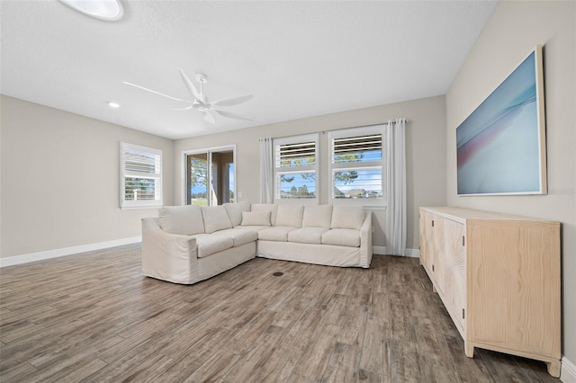 unfurnished living room with dark hardwood / wood-style floors, plenty of natural light, and ceiling fan