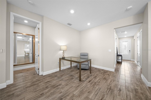 office featuring a textured ceiling and dark wood-type flooring