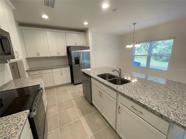 kitchen with sink, light stone countertops, a notable chandelier, white cabinetry, and stainless steel appliances