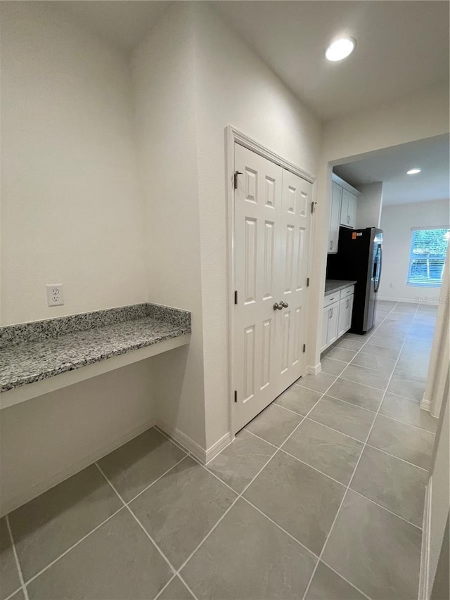 hallway with light tile patterned floors