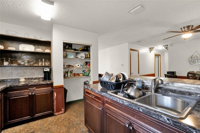 kitchen featuring a textured ceiling, ceiling fan, and sink