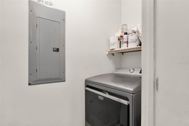 clothes washing area featuring electric panel and washer / clothes dryer