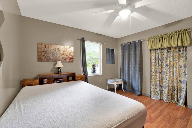 bedroom featuring ceiling fan and hardwood / wood-style flooring