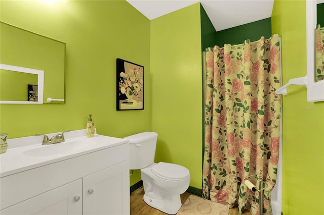 bathroom featuring hardwood / wood-style floors, vanity, toilet, and a shower with shower curtain